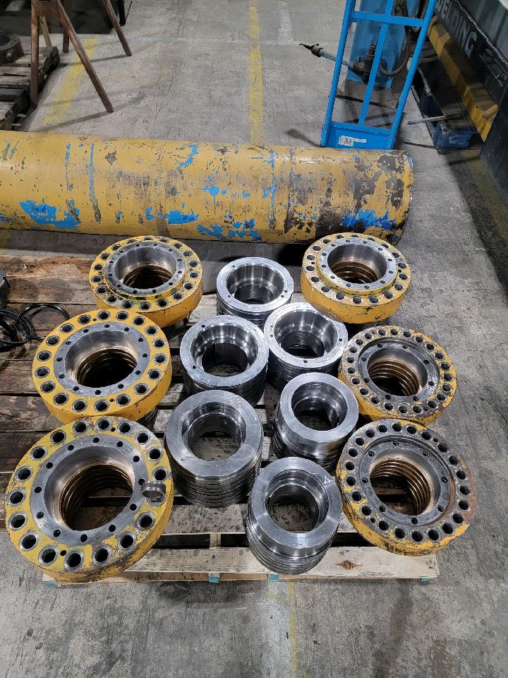 Hydraulic cylinders staged on the bench for repair